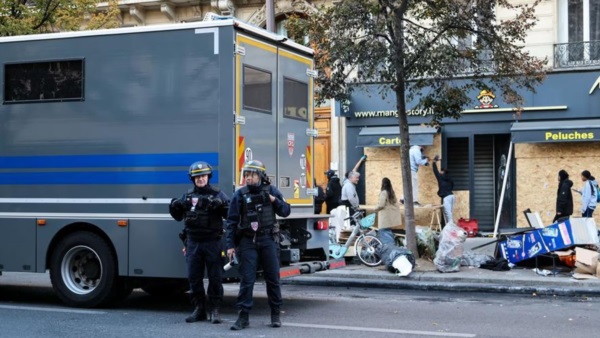Fuerzas de seguridad vigilan frente a una tienda. Foto: Agencia NA (Xinhua).